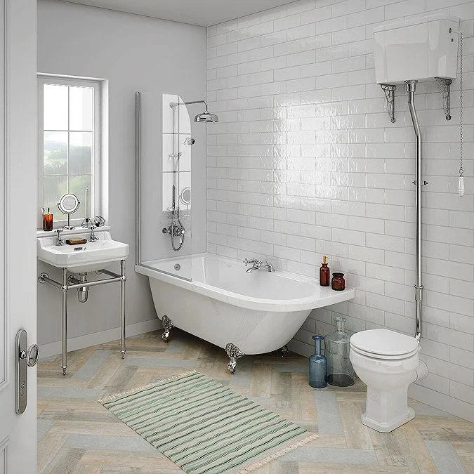 Light bathroom with freestanding bath and white wall tiles
